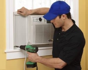 Service Tech Installing a Window AC