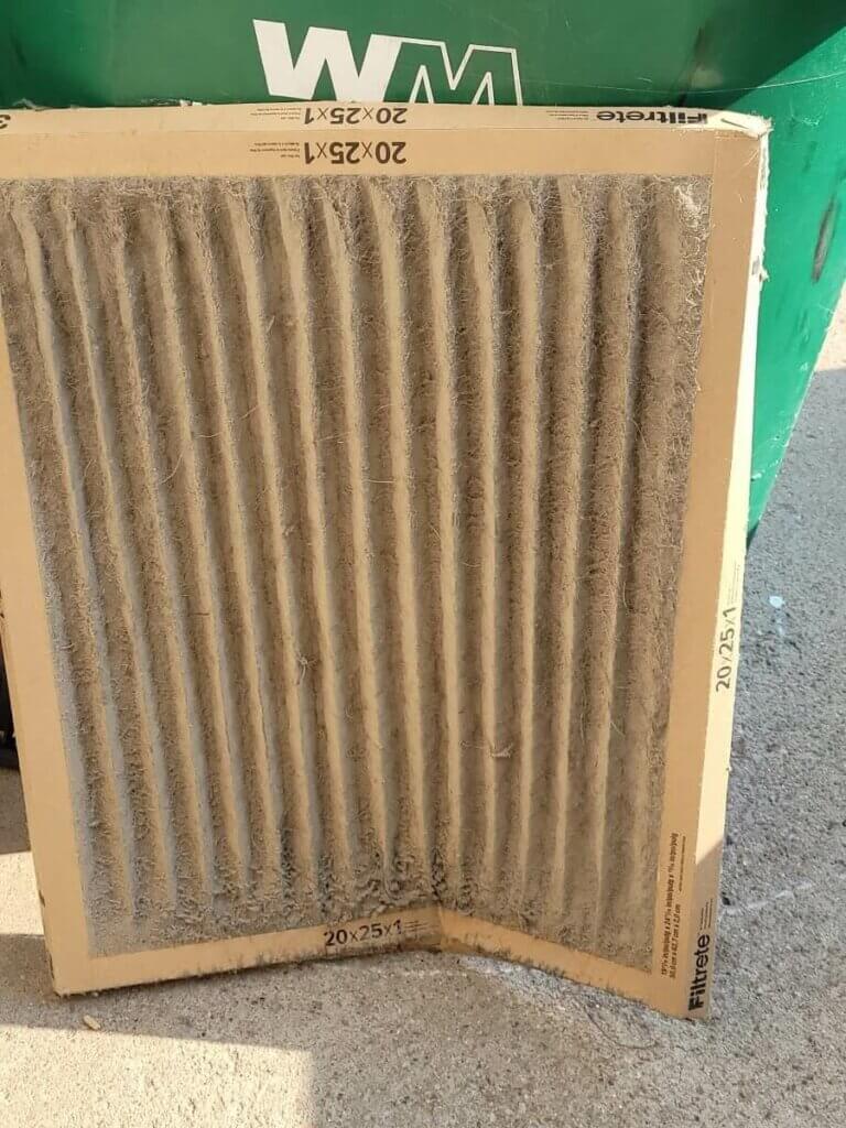 The image shows a dirty air filter that the mechanics at Polar Bear Mechanical found during one of their jobs. The air filter is covered in dust and dirt is unable to do its job anymore.