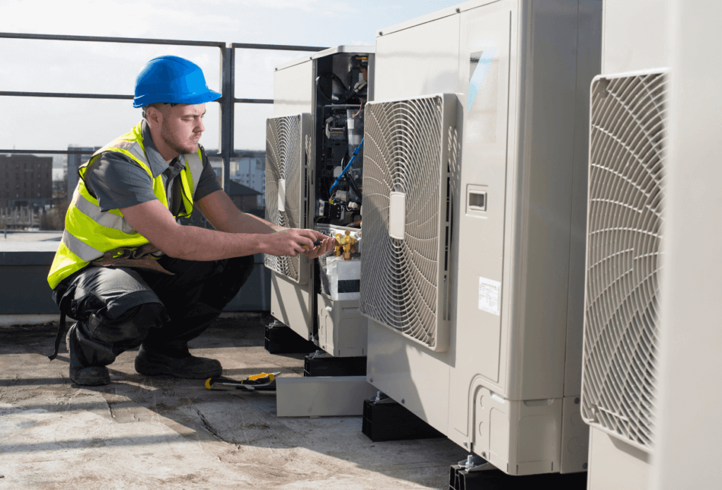 A picture of an HVAC expert installing a rooftop HVAC unit.